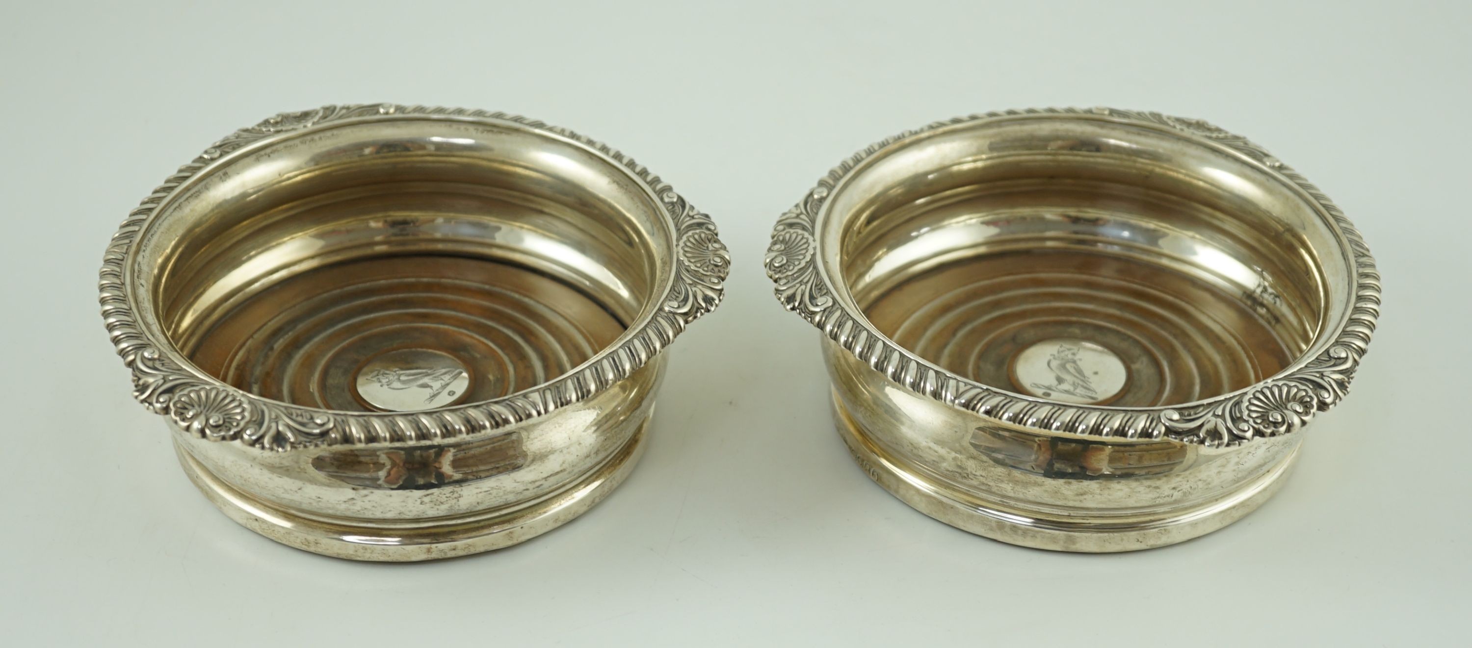 A pair of George IV silver wine coasters by Benjamin Smith III